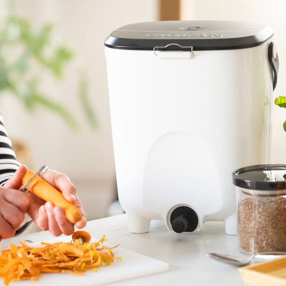 Person using a vegetable peeler with a white food chopper in the background