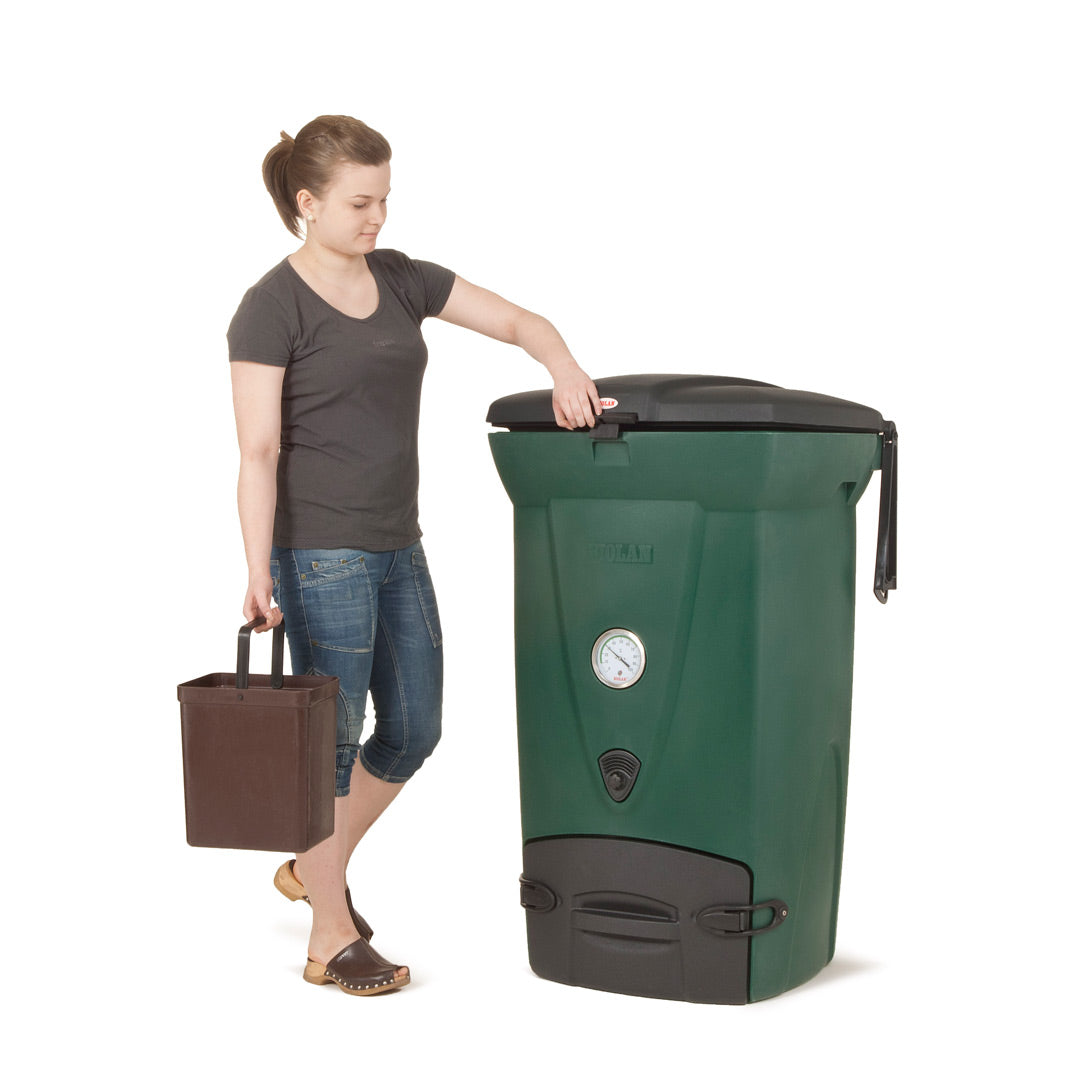 Woman interacting with a large green compost bin on a white background
