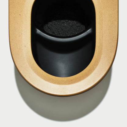 Close-up of toilet carbon cover in a wooden frame on a white background